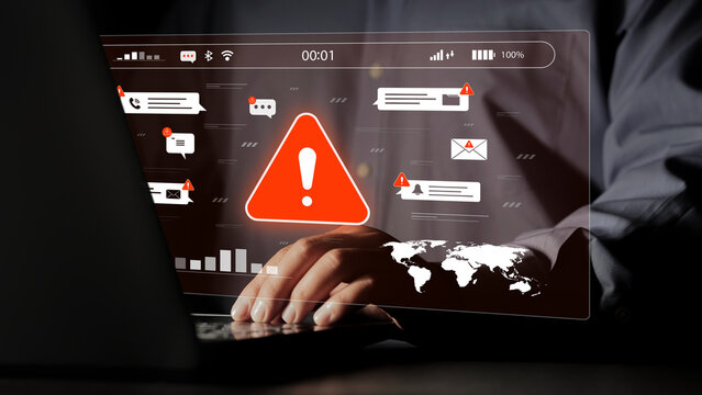 Cybersecurity breach alerts display a red warning symbol and an image of a business person typing on a laptop, indicating an email scam. This is to ensure technological security and prevent online att
