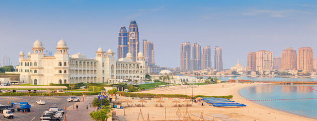 Fototapeta premium 1 December 2025, Doha, Qatar: Katara cultural village traditional architecture with beach and modern city skyline