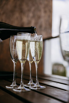Pouring champagne into flute with sparkling bubbles for celebration toast
