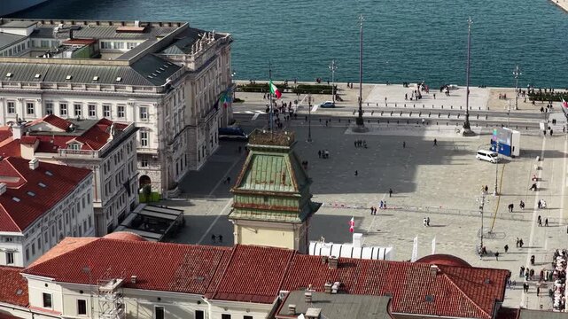Aerial view of Piazza Unita d'Italia shows the lively square with its buildings and people, contrasting with the sea, Trieste, Friuli-Venezia Giulia, Italy.
