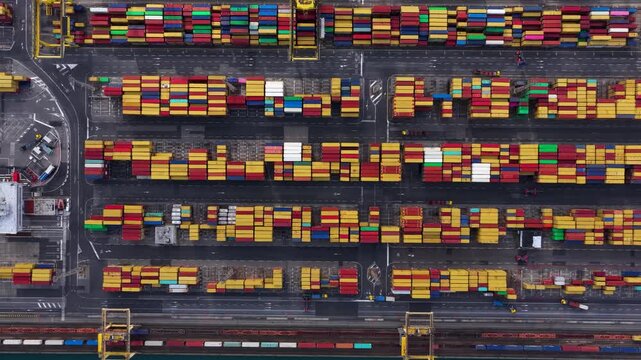 Aerial view of stacked shipping containers in a port, creating a vibrant tapestry of colors and patterns, Trieste, Friuli-Venezia Giulia, Italy.