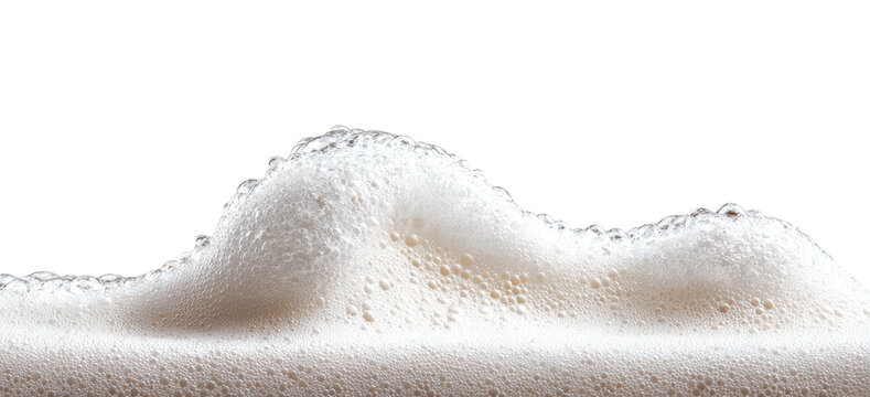 Close-up of frothy, off-white foam with a wave-like structure against a black background