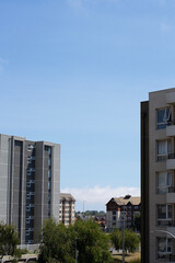 Modern Residential Apartment Buildings with Glass Balconies and Bright Sky