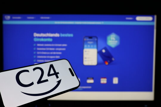 Kiel, Germany - 02-04-2026: Smartphone displaying German digital bank C24 Bank logo in front of companys webpage