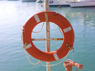 Bright Orange Lifebuoy By Calm Sea