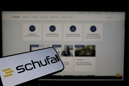Kiel, Germany - 02-04-2026: Smartphone displaying German credit bureau SCHUFA logo in front of companys webpage