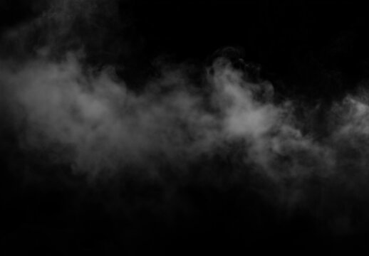 Dramatic gray smoke cloud on black background with deep contrast
