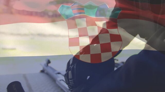 Person entering from right side gripping rifle inspecting parts under Croatian flag overlay