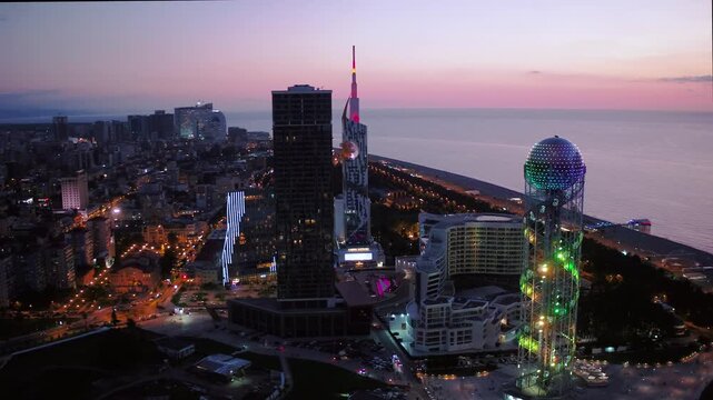 Aerial drone footage of Batumi city, Georgia, showcasing modern architecture, Black Sea coastline, city skyline, streets, and urban development. Cinematic cityscape highlighting .