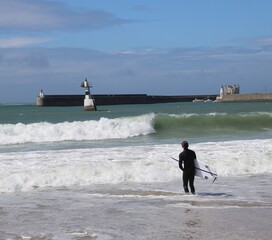 A surfer on the beach in Quiberon, Brittany, France