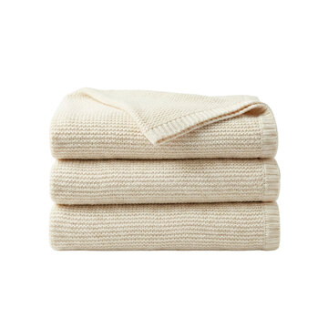 Stacked cream waffle knit cotton blankets isolated