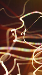 Soft glowing multicolored ribbon-like trails swirling smoothly through a warm dark background