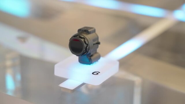 Close-up of an automotive ultrasonic parking sensor displayed on a stand, representing modern vehicle safety technology and advanced driver assistance systems. China.