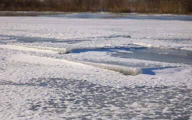Winter landscape with snow. Frozen Vistula, ice floe on the Vistula river, frost, snow, sharp frost at winter.