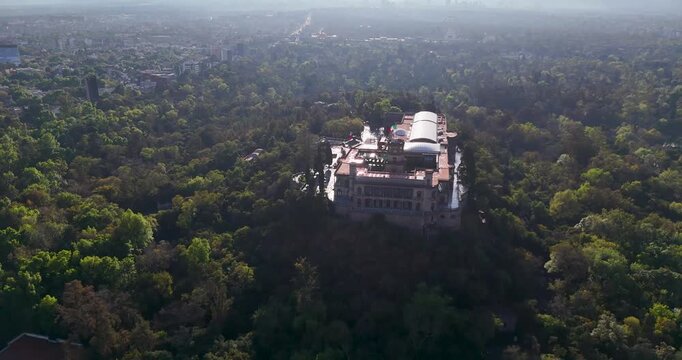 Aerial observation video of Chapultepec Castle set within Chapultepec Forest, a historic and iconic monument of Mexico City, highlighting its architectural presence and surrounding green landscape.