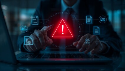 Businessman interacting with warning sign on laptop screen in modern office