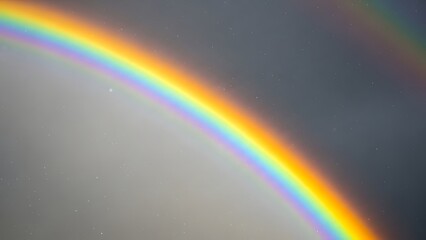 Fototapeta premium A vibrant rainbow arcs across a dramatic sky, a beautiful display of nature's optical phenomenon after a rain shower
