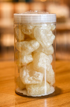 A tall jar filled with deep-fried cow skin (Kerupuk Kulit Sapi), commonly known as Rambak.