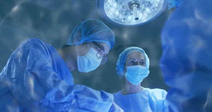Camera pulling back, revealing surgical team operating, watching lamp and monitor for teamwork