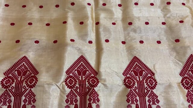 Tilt down shot of Assamese Traditional Toss Muga chador , Assamese Muga silk chador 