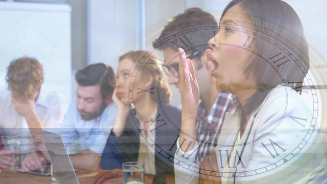 Team around laptops in business, clock overlay fading signaling long meeting, right woman yawning