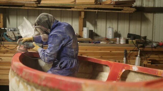 Sanding gunwale and transom of fiberglass fishing boat