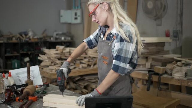 Carpenter is working at workshop. Small business and craft product.