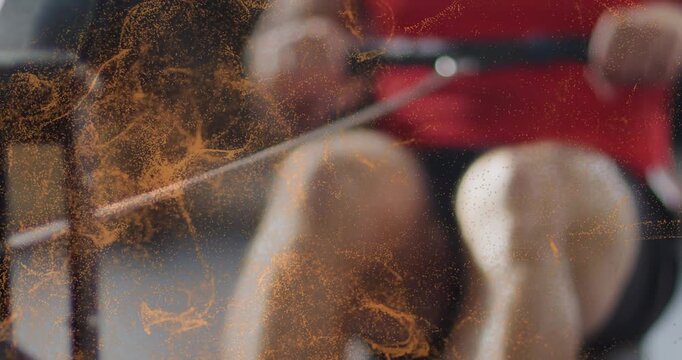 Male athlete initiating drive by pushing legs, rowing ergometer training strokes, orange overlaying