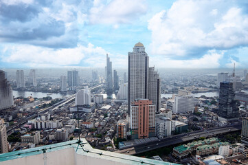Obraz premium Urban City Skyline View with High-Rise Buildings and Blue Sky