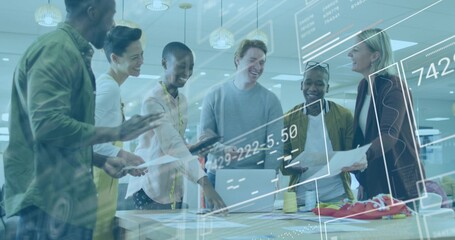 Design team collaborating over plans and swatches at office, in blazers with laptop and red shoe