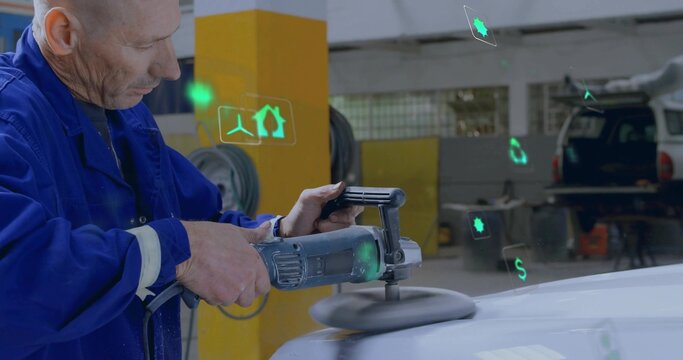 Buffing technician wearing blue coveralls using handheld polisher on car hood at shop, copy space