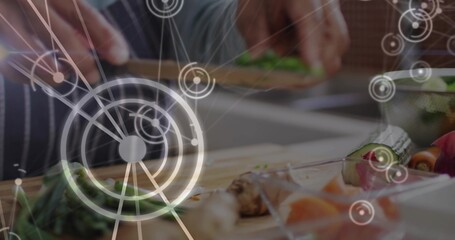 Chopping Indian woman in dark striped top on kitchen counter with wooden board, knife, AR overlays © vectorfusionart