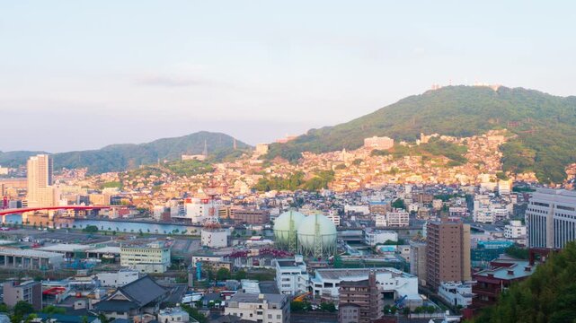 Nagasaki, Japan. Aerial timelapse made from a hill in Nagasaki, Japan, with a view over the entire center, including the bay and the hills. Cloudy and sunny day in summer, apnning video