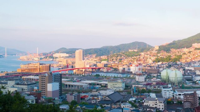 Nagasaki, Japan. Aerial timelapse made from a hill in Nagasaki, Japan, with a view over the entire center, including the bay and the hills. Cloudy and sunny day in summer