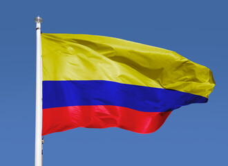 Close-up view of Colombia national flag waving in the wind.. Blue sky background