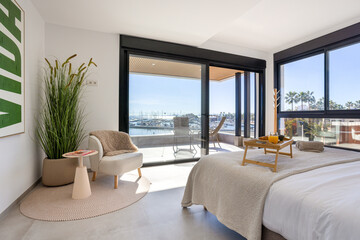 Fototapeta premium Coastal bedroom with terrace access and panoramic marina view
