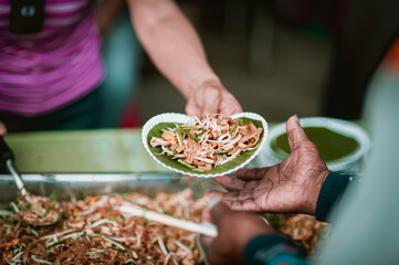 The hands of the hungry get food from the hands of volunteers, Food Donations for Homeless