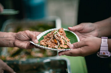 The hands of the hungry are asking for food from the donor,Out to the Homeless and Hungry