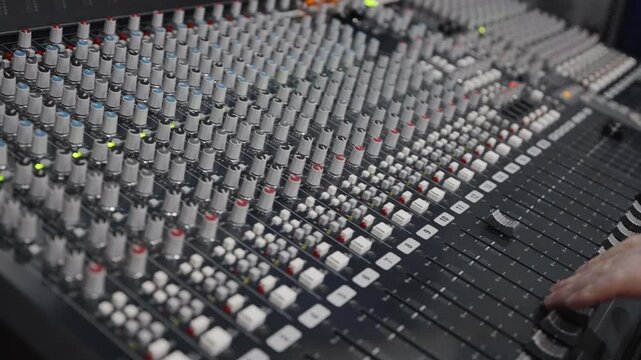 Engaging with detailed analog mixing tools and visual signal indicators