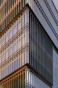 Corporate modern architecture facade showing a corner with vertical windows and geometry shaping pattern for business finance background and urban design needs