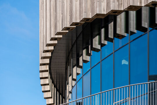 Corporate skyline seen in modern office architecture where a curve of glass facade windows builds reflection for finance focused business background and design