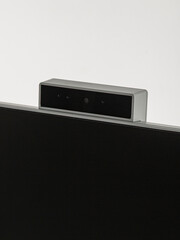 Obraz premium Monitor's camera is in close-up on a white background.