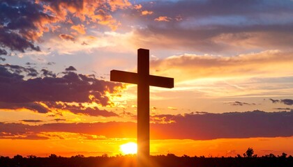 Glowing Christian cross silhouette against dramatic sunset sky with red and orange clouds. Spiritual and religious background concept for faith and worship