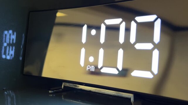 Modern digital alarm clock with a mirror finish displaying 1:09 PM in bright white LED numbers