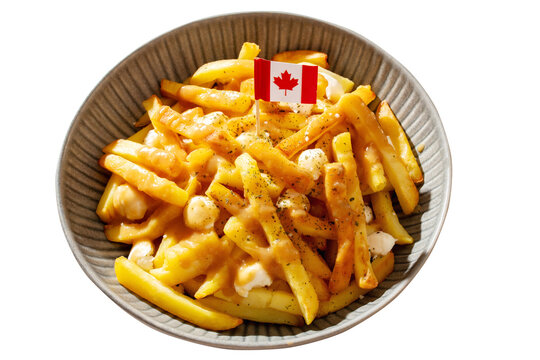Traditional Canadian poutine with fries, cheese curds, and gravy, decorated with Canadian flag isolated