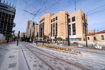 Fototapeta premium Tram stop in the center of modern district in Jerusalem with skyscrapers, Israel.