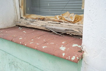Old window frame in a house, time to renovate (symbolic)
