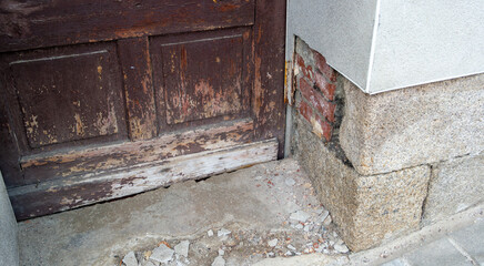 Old, dilapidated steps in the house entrance with peeling plaster; time for renovation