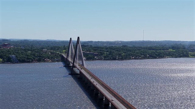 Wide aerial tracking left, Puente Internacional San Roque Gonzalez stretching across river