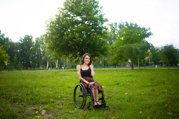 Woman in Wheelchair Enjoying Green Park Landscape